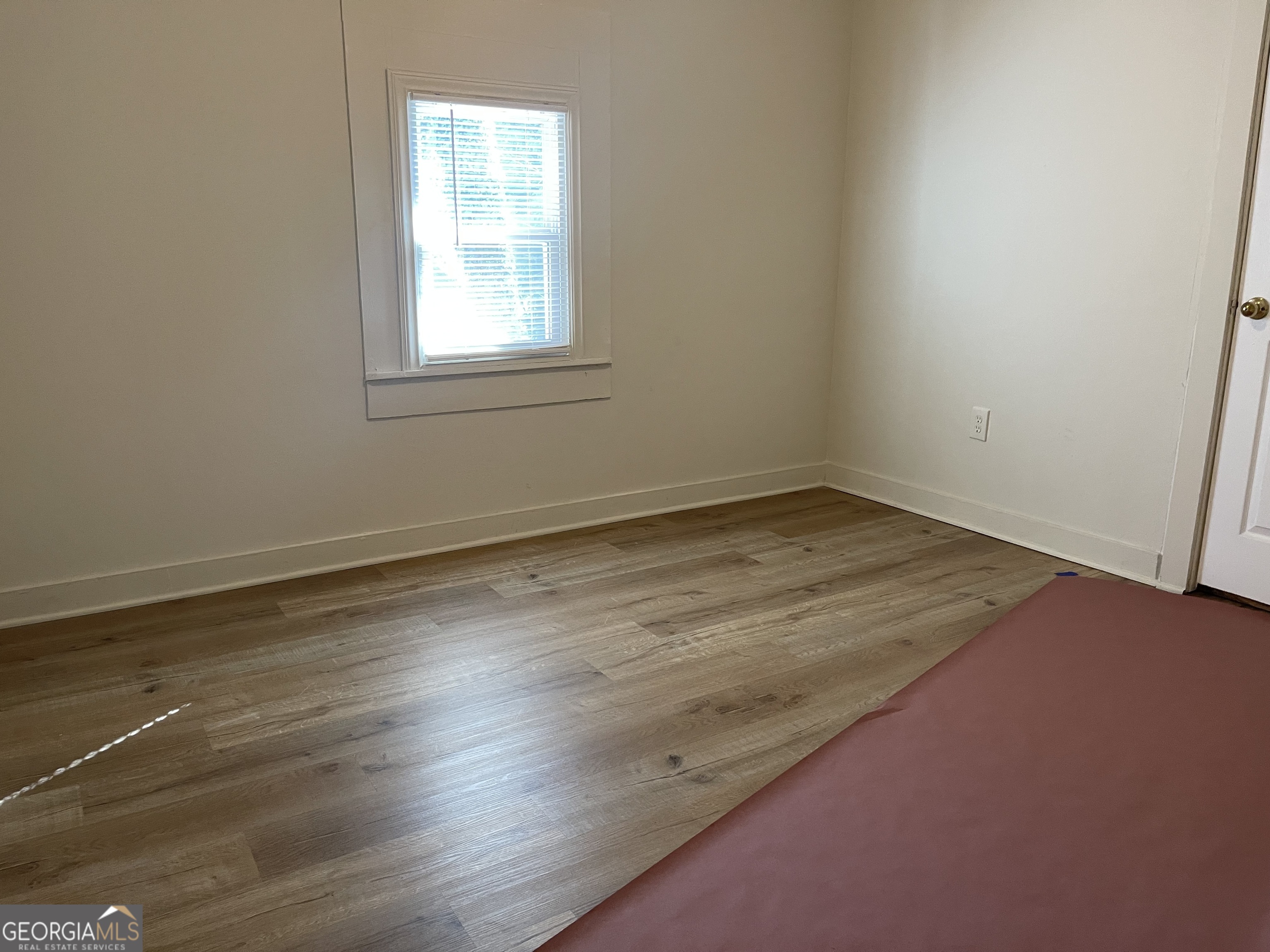 478 South Pond Street Toccoa, GA 30577 - Photo 20 of 46 an empty room with wooden floor and windows