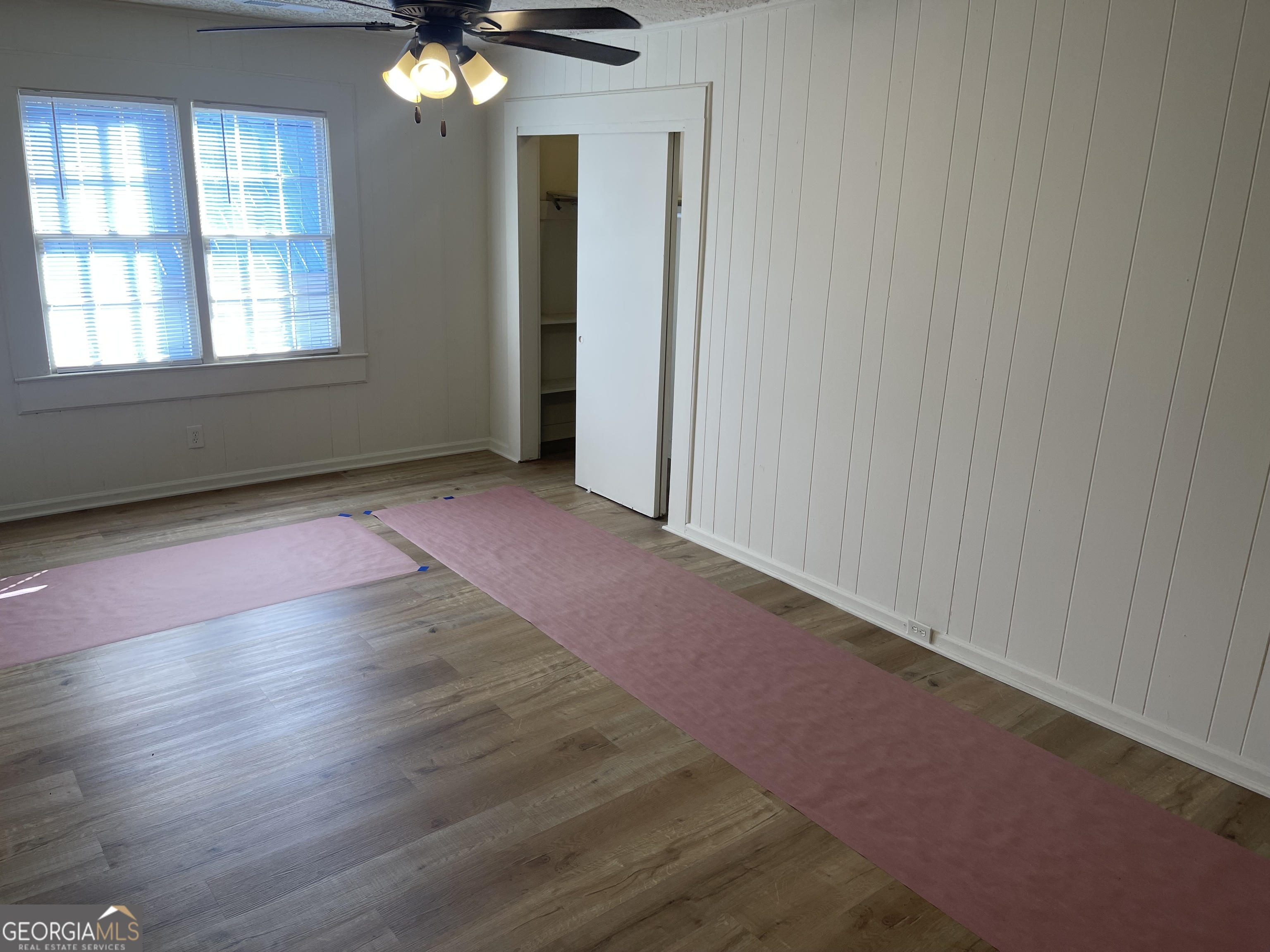 478 South Pond Street Toccoa, GA 30577 - Photo 25 of 46 an empty room with wooden floor fan and windows