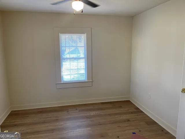 wooden floor in an empty room with a window