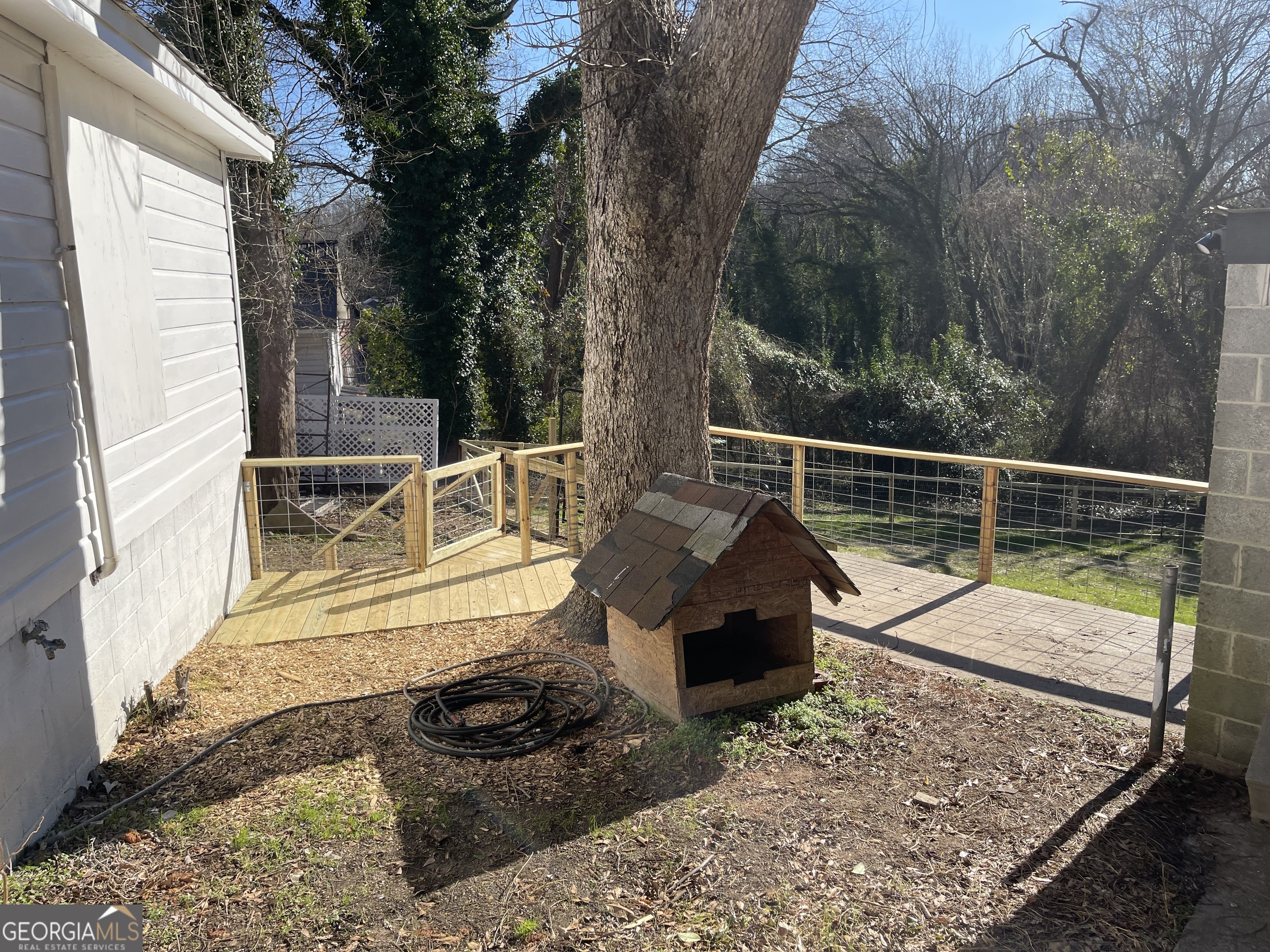 478 South Pond Street Toccoa, GA 30577 - Photo 34 of 46 a view of a deck with a floor to ceiling window and wooden fence