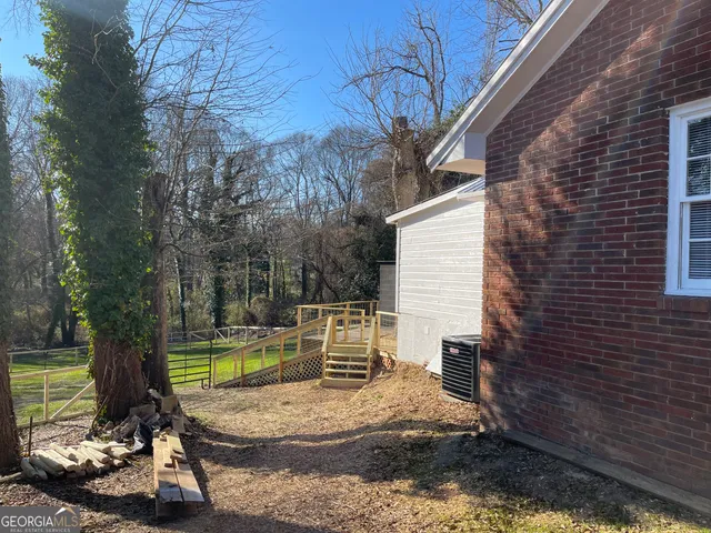 a view of a backyard with plants and a patio