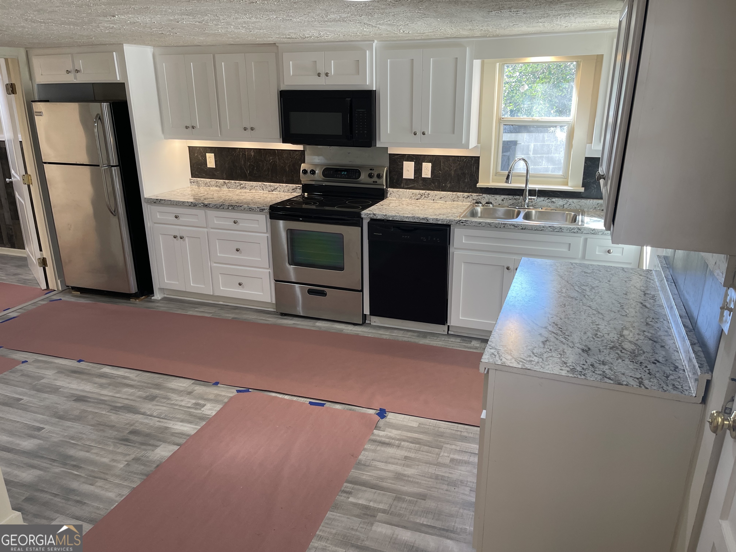 478 South Pond Street Toccoa, GA 30577 - Photo 6 of 46 a kitchen with stainless steel appliances granite countertop a stove a sink dishwasher a refrigerator and a microwave