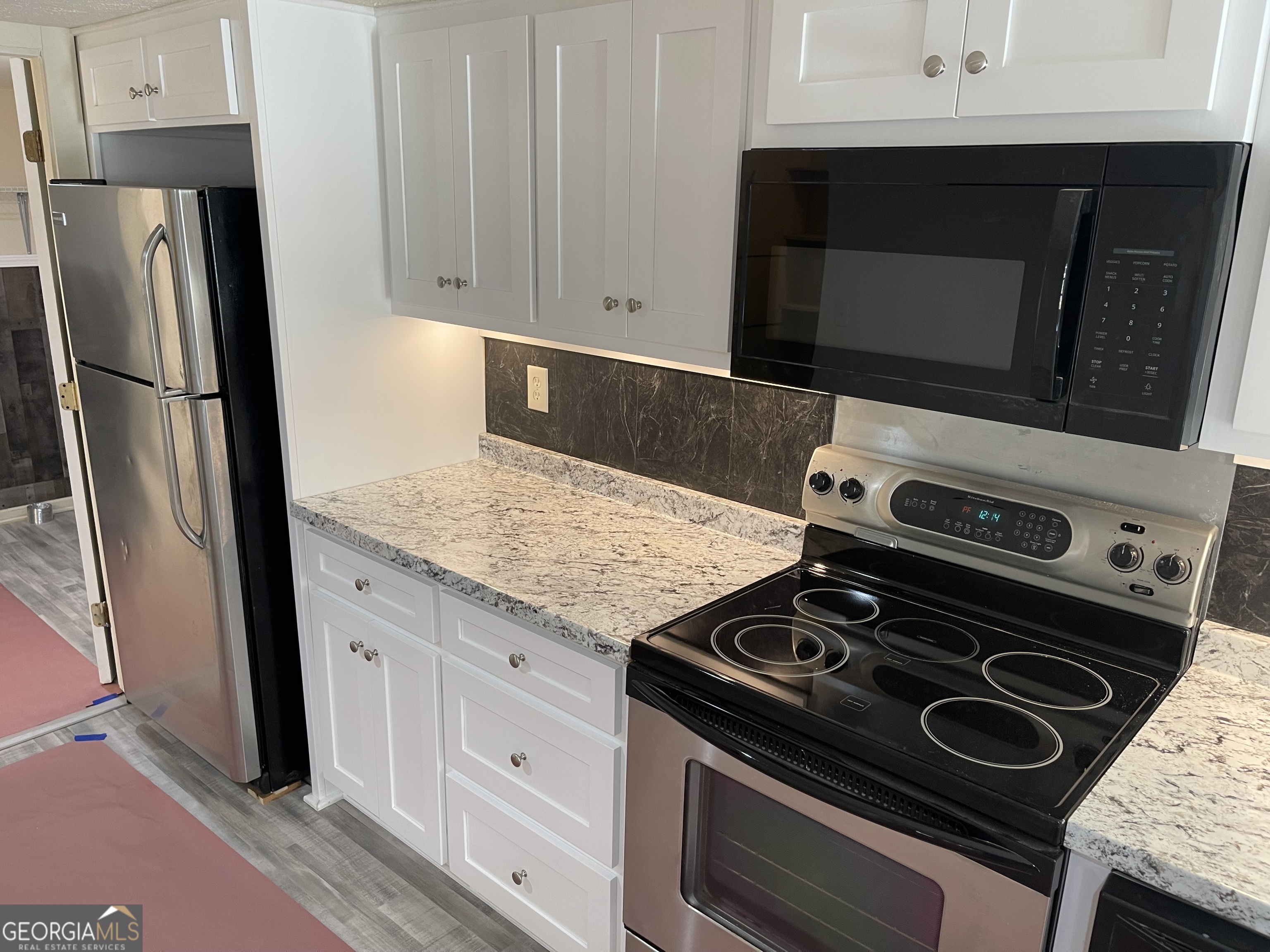 478 South Pond Street Toccoa, GA 30577 - Photo 8 of 46 a kitchen with a stove and a microwave