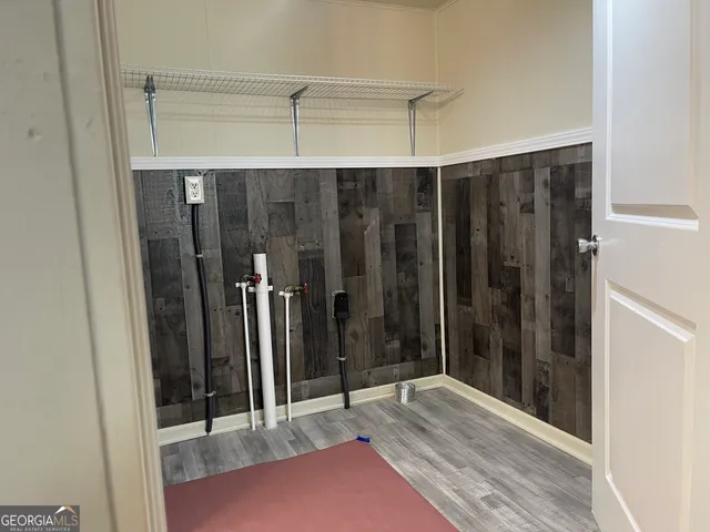 a view of a room with wooden floor and windows