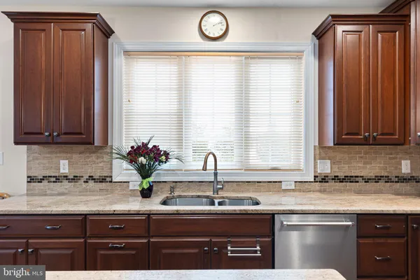 a kitchen with granite countertop a sink and a window