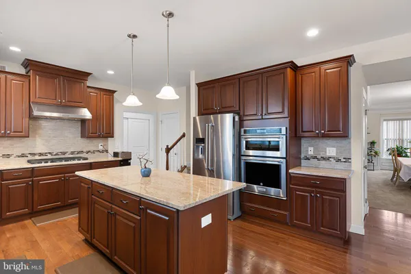a kitchen with a stove a sink and a refrigerator