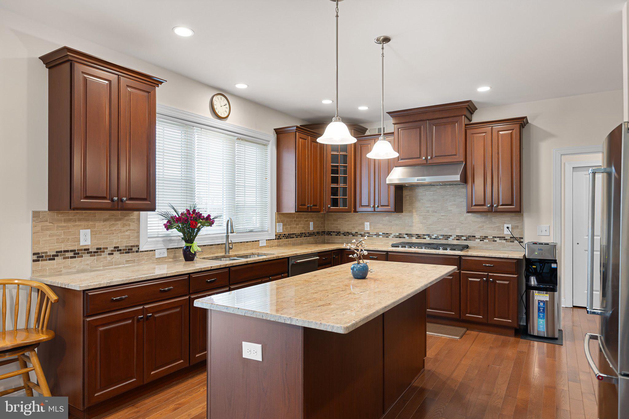 1020 Matthew Way New Castle, DE 19720 - Photo 14 of 55 a kitchen with a sink a stove a refrigerator and a center island