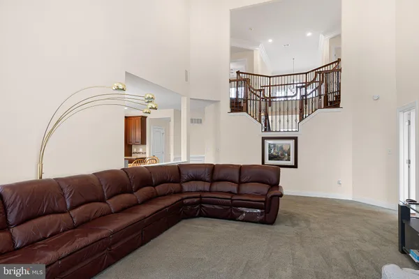 a living room with furniture a rug and white walls
