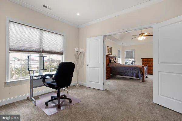a view of a livingroom with workspace and a window
