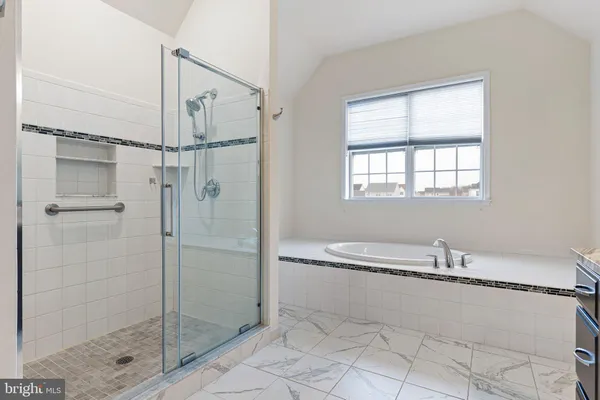 a bathroom with a bathtub and a shower
