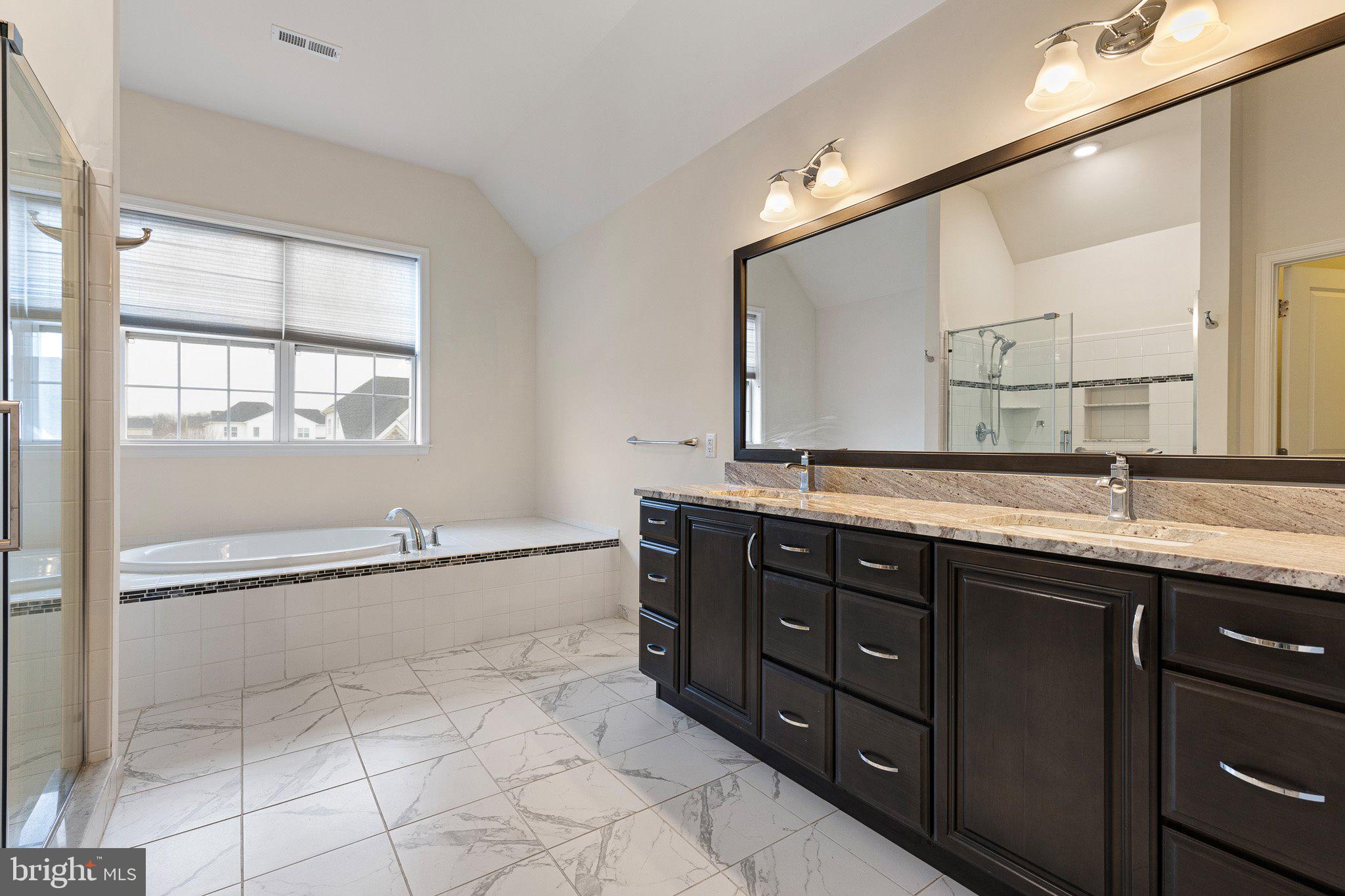 1020 Matthew Way New Castle, DE 19720 - Photo 30 of 55 a spacious bathroom with a granite countertop sink mirror and a bath tub