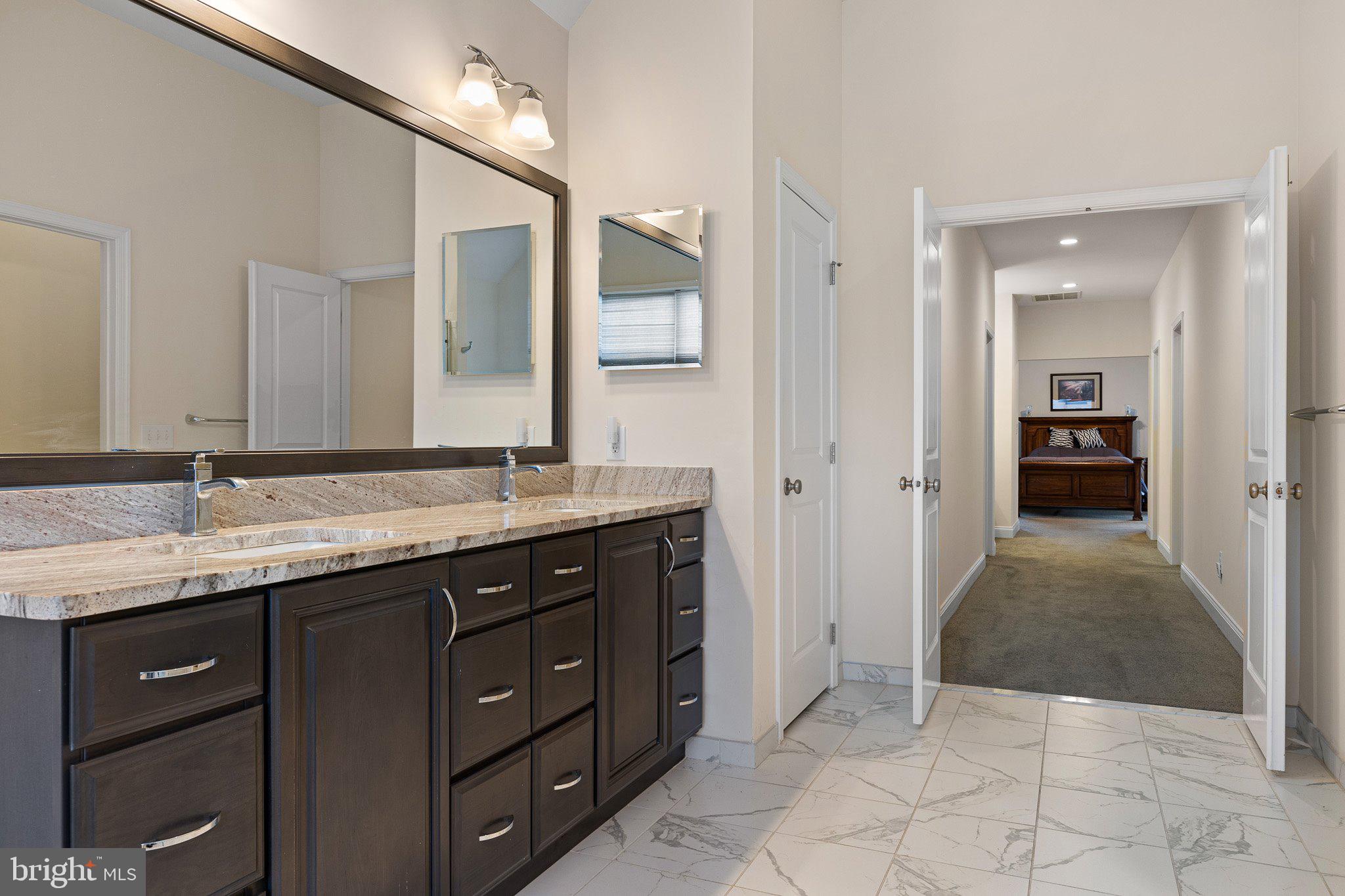 1020 Matthew Way New Castle, DE 19720 - Photo 31 of 55 a spacious bathroom with a granite countertop sink and a mirror