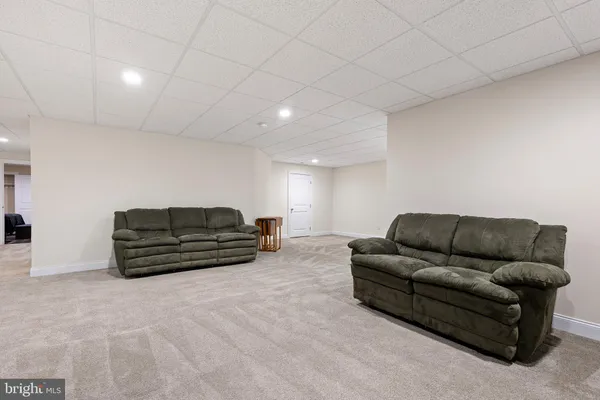 a bedroom with furniture and wooden floor