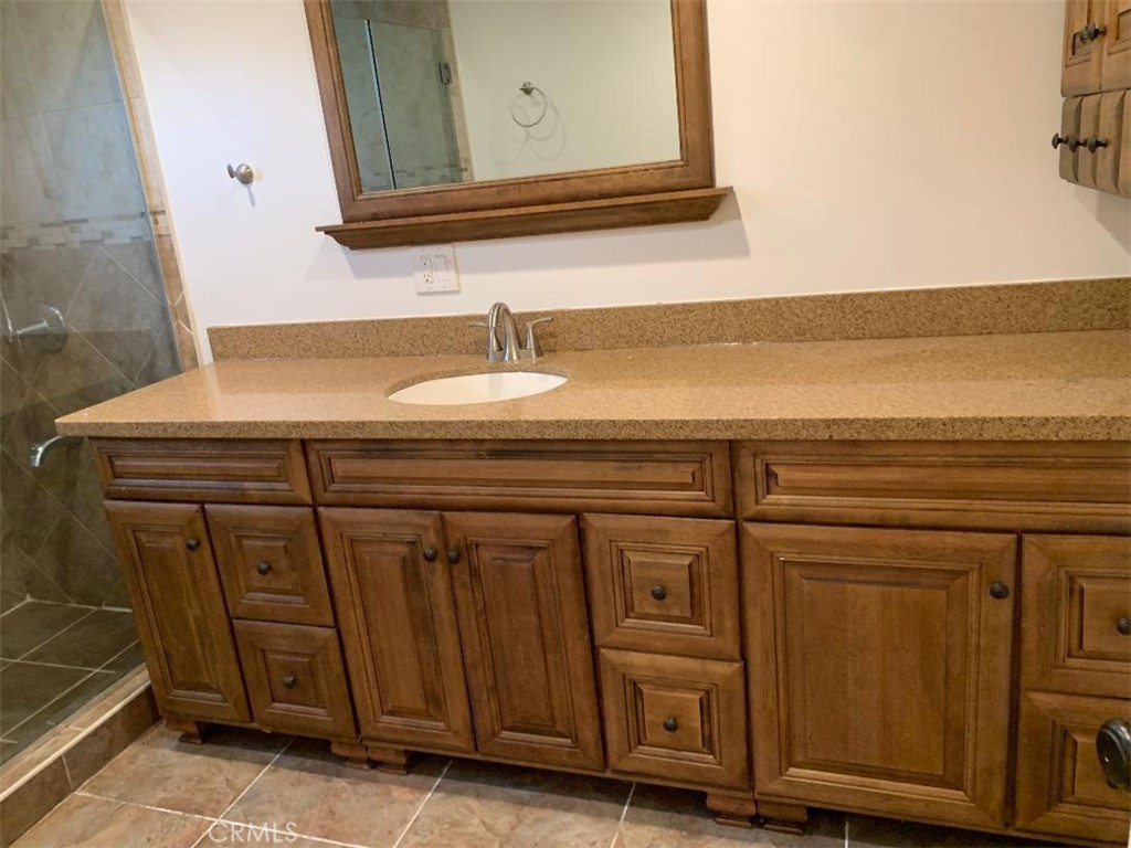 18233 Welby Way Reseda, CA 91335 - Photo 12 of 15 a bathroom with a sink a mirror and vanity