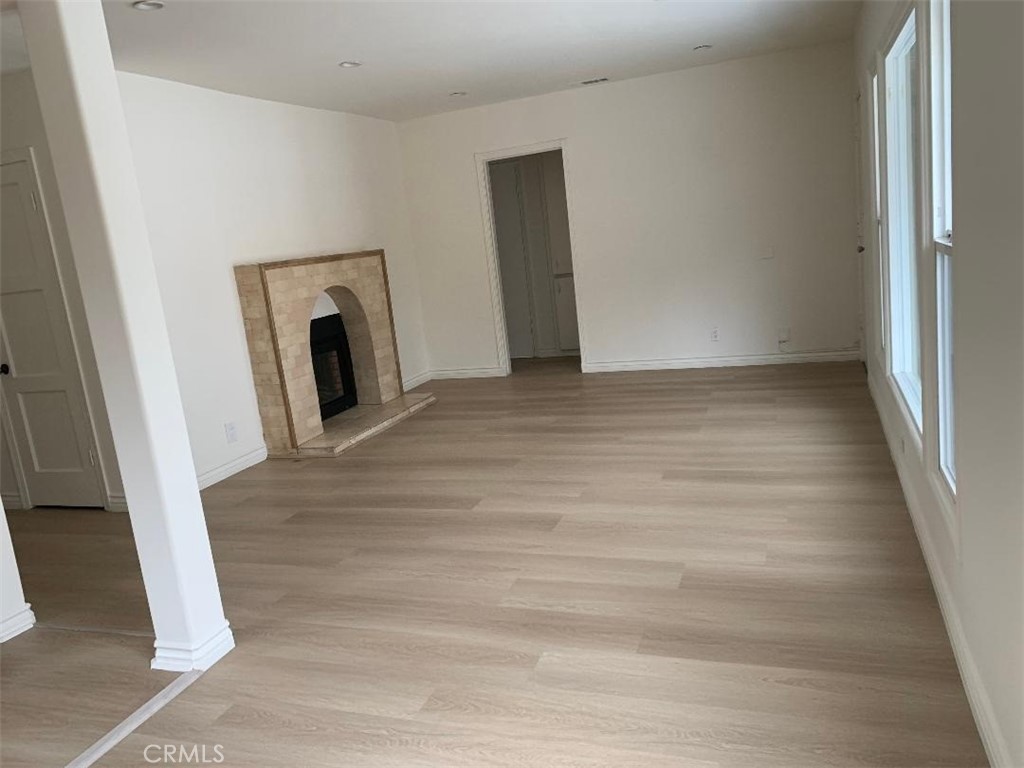 18233 Welby Way Reseda, CA 91335 - Photo 4 of 15 a view of a hallway with wooden floor