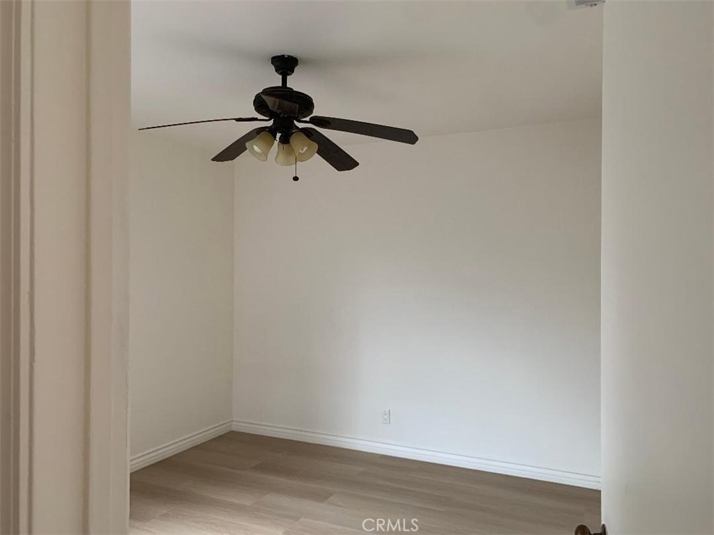 18233 Welby Way Reseda, CA 91335 - Photo 8 of 15 a view of a ceiling fan and wooden floor