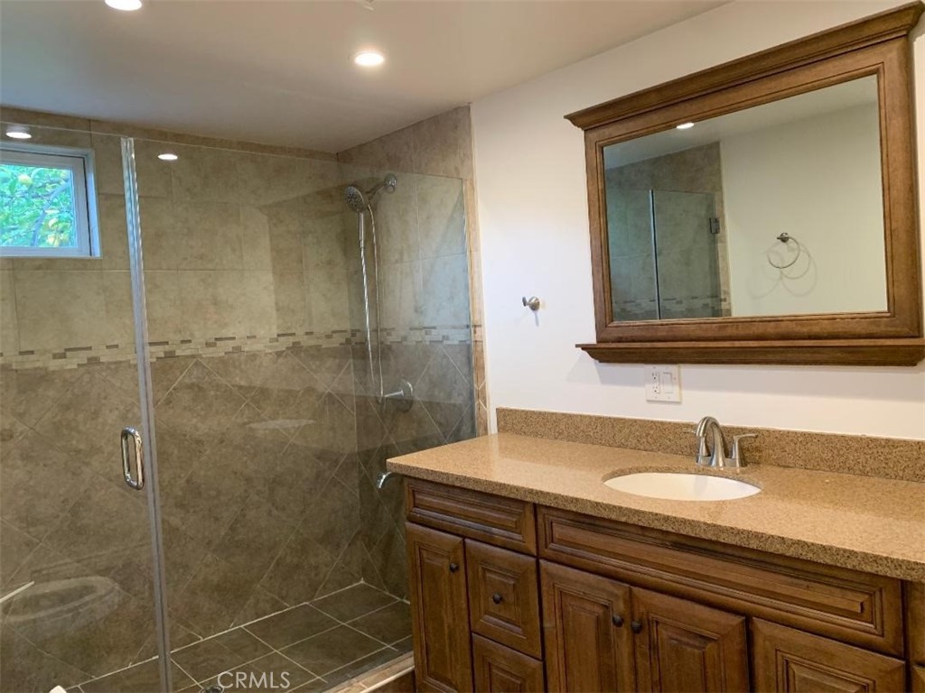 18233 Welby Way Reseda, CA 91335 - Photo 10 of 15 a bathroom with a sink shower and a mirror