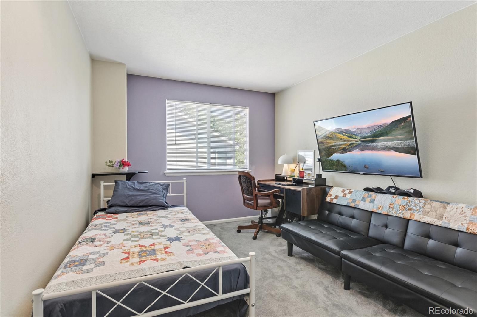 334 Octillo Street Brighton, CO 80601 - Photo 17 of 39 a living room with furniture and a flat screen tv