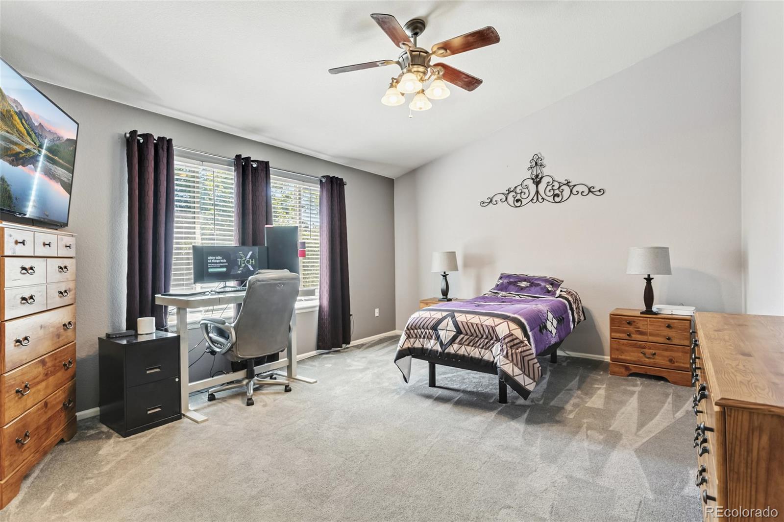 334 Octillo Street Brighton, CO 80601 - Photo 19 of 39 a bedroom with a bed and a chandelier