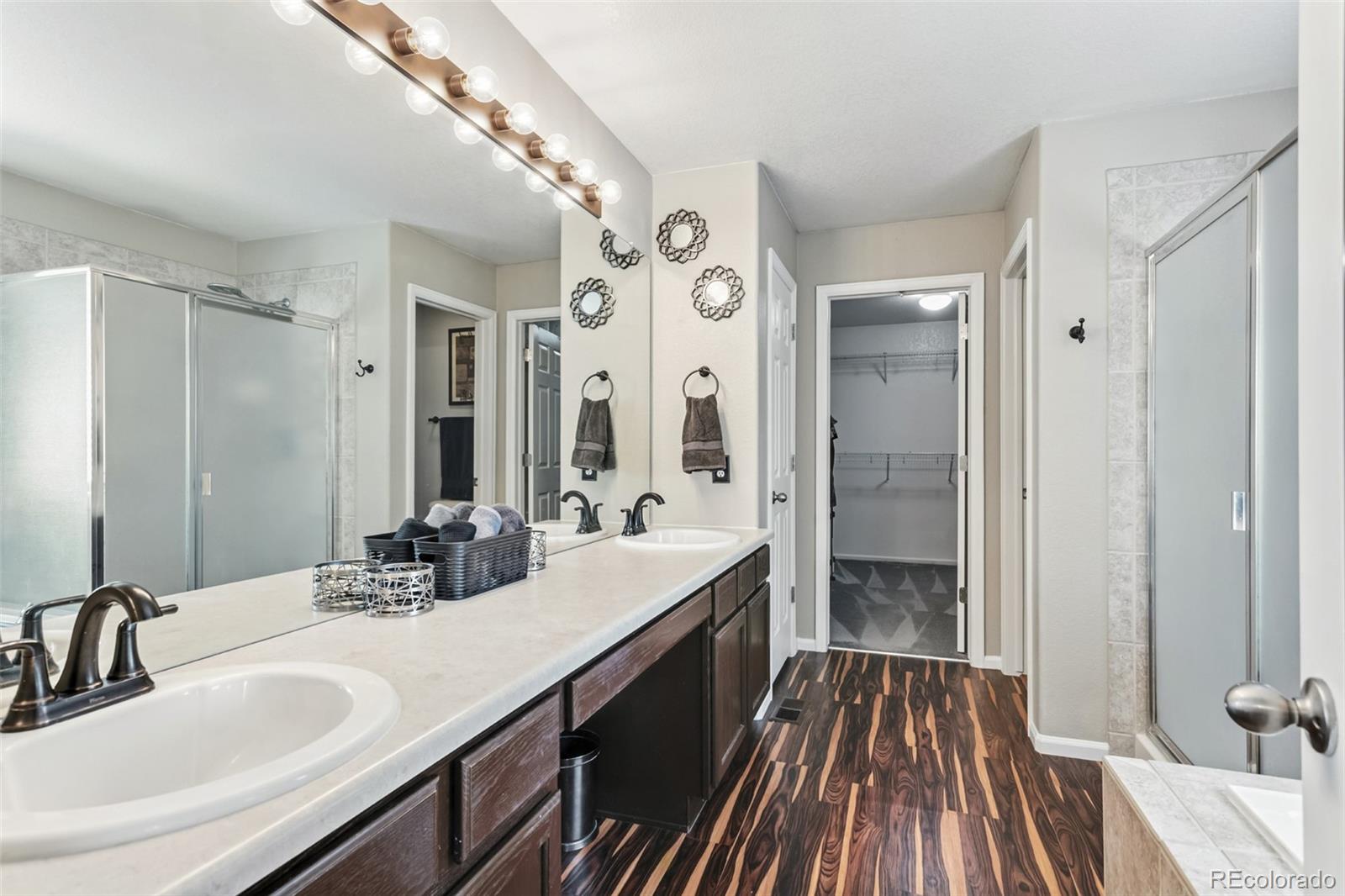 334 Octillo Street Brighton, CO 80601 - Photo 20 of 39 a bathroom with a double vanity sink and mirror