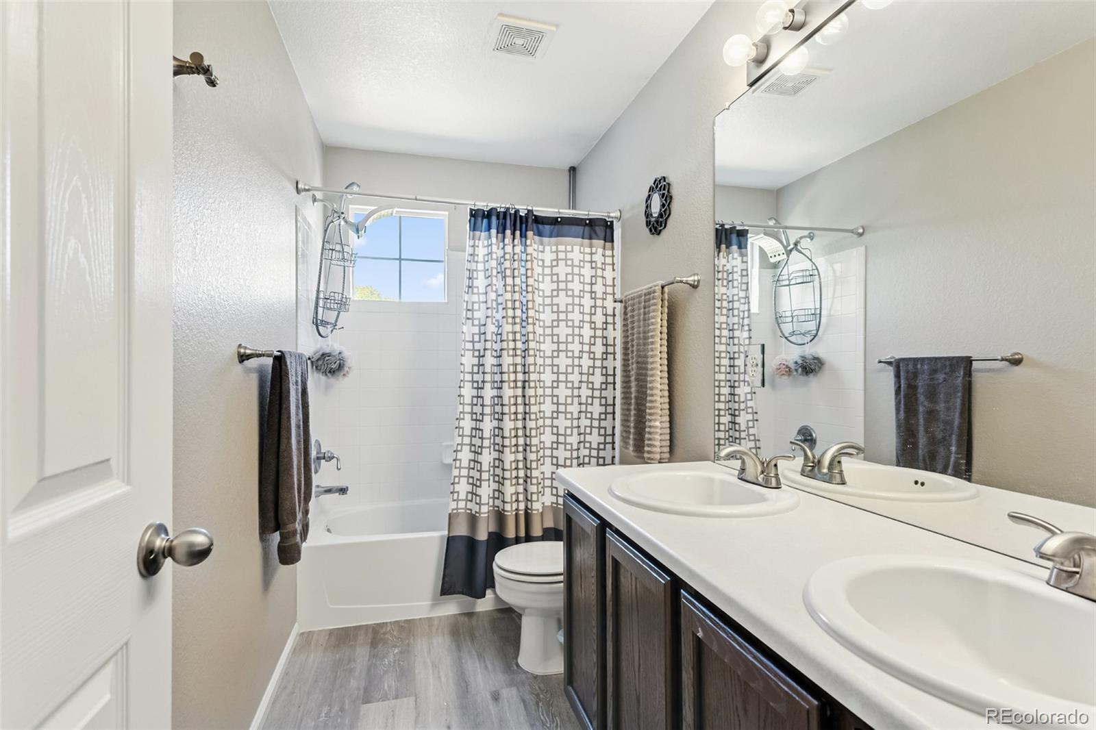 334 Octillo Street Brighton, CO 80601 - Photo 22 of 39 a bathroom with a double vanity sink toilet and shower