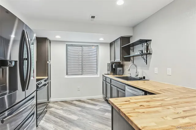 a kitchen with a sink stove and refrigerator