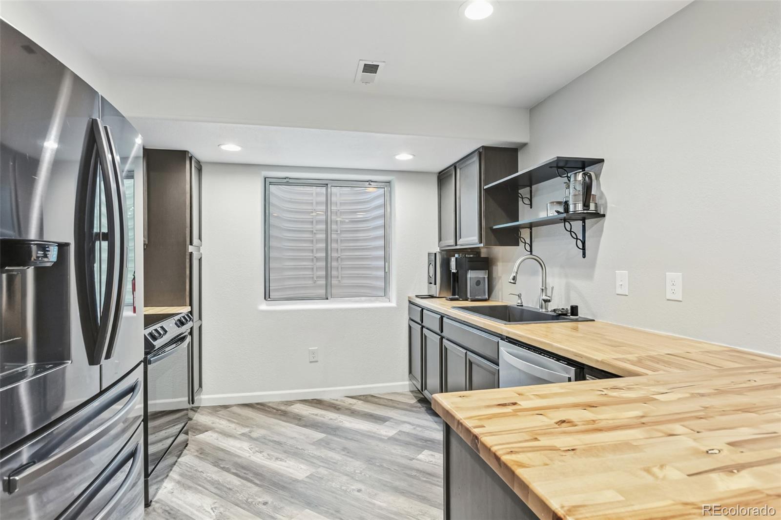 334 Octillo Street Brighton, CO 80601 - Photo 31 of 39 a kitchen with a sink stove and refrigerator