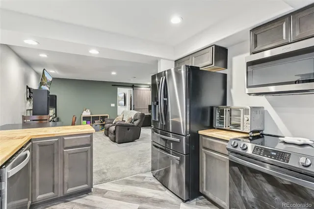 a kitchen with refrigerator and stove