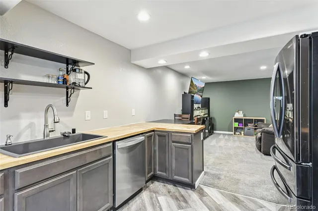 a kitchen with a sink appliances and cabinets