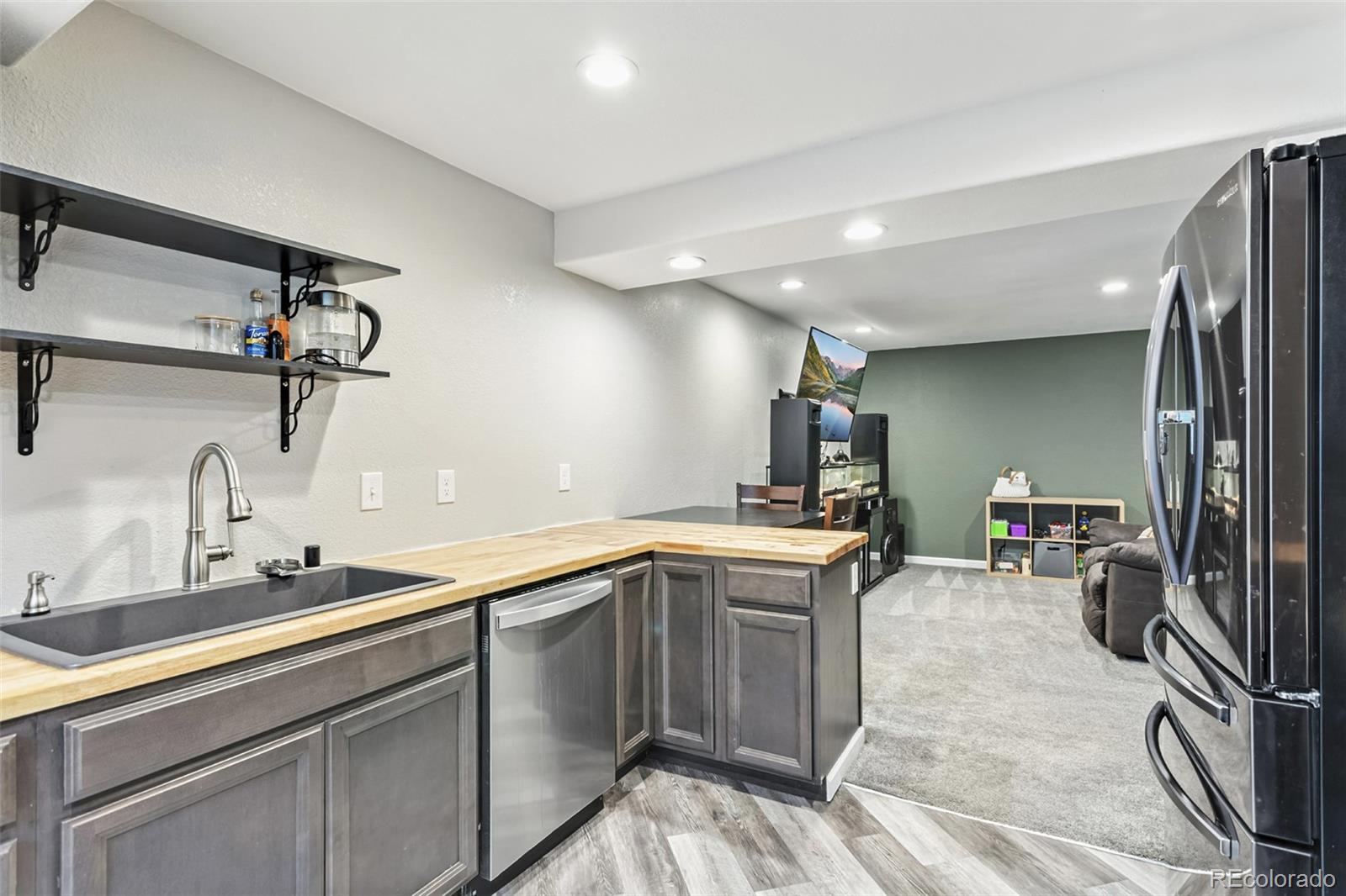 334 Octillo Street Brighton, CO 80601 - Photo 33 of 39 a kitchen with a sink appliances and cabinets