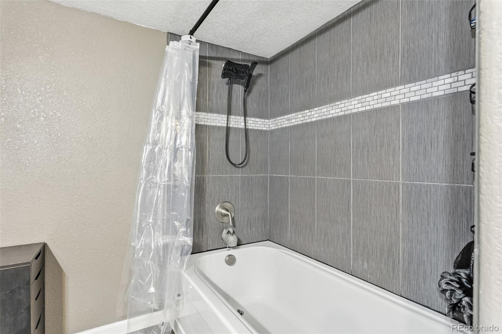 334 Octillo Street Brighton, CO 80601 - Photo 35 of 39 a bathroom with a bathtub and shower