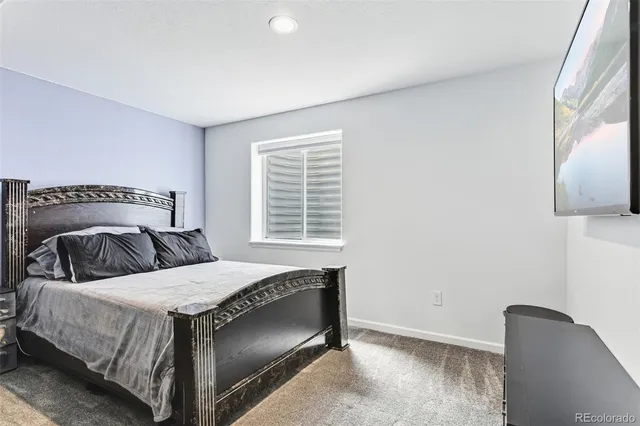 a bedroom with a bed and a chair