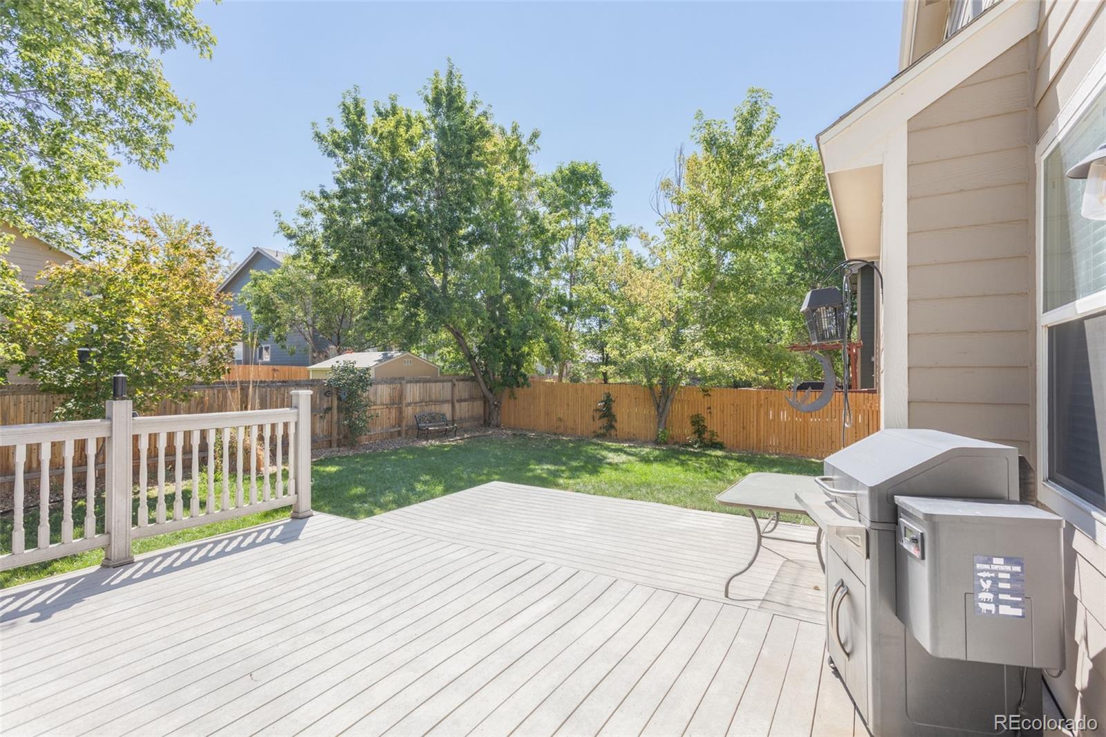 334 Octillo Street Brighton, CO 80601 - Photo 38 of 39 a view of backyard with a deck and a garden