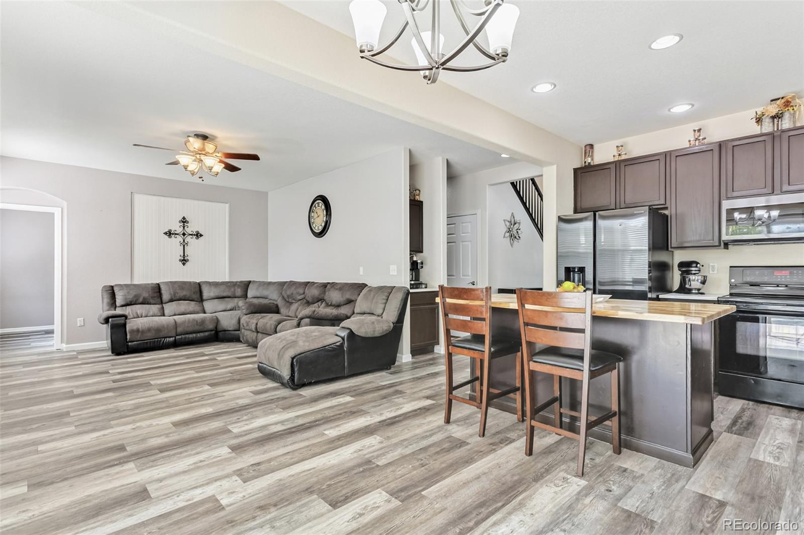 334 Octillo Street Brighton, CO 80601 - Photo 10 of 39 a living room with lots of furniture and kitchen view