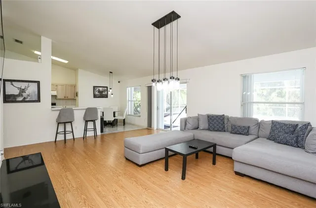 a living room with furniture and a chandelier