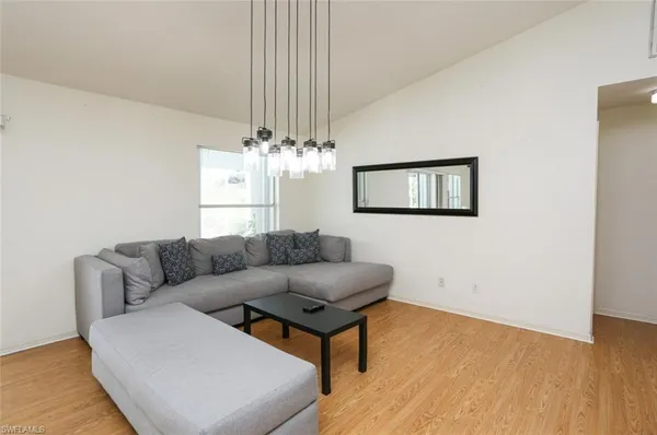 a living room with furniture and a chandelier