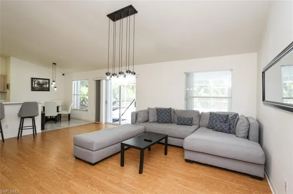 a living room with furniture and a chandelier