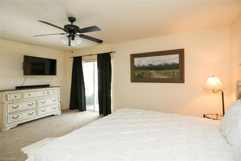 7775 Scarlet Court Naples, FL 34104 - Photo 21 of 30 Bedroom featuring ceiling fan and light colored carpet