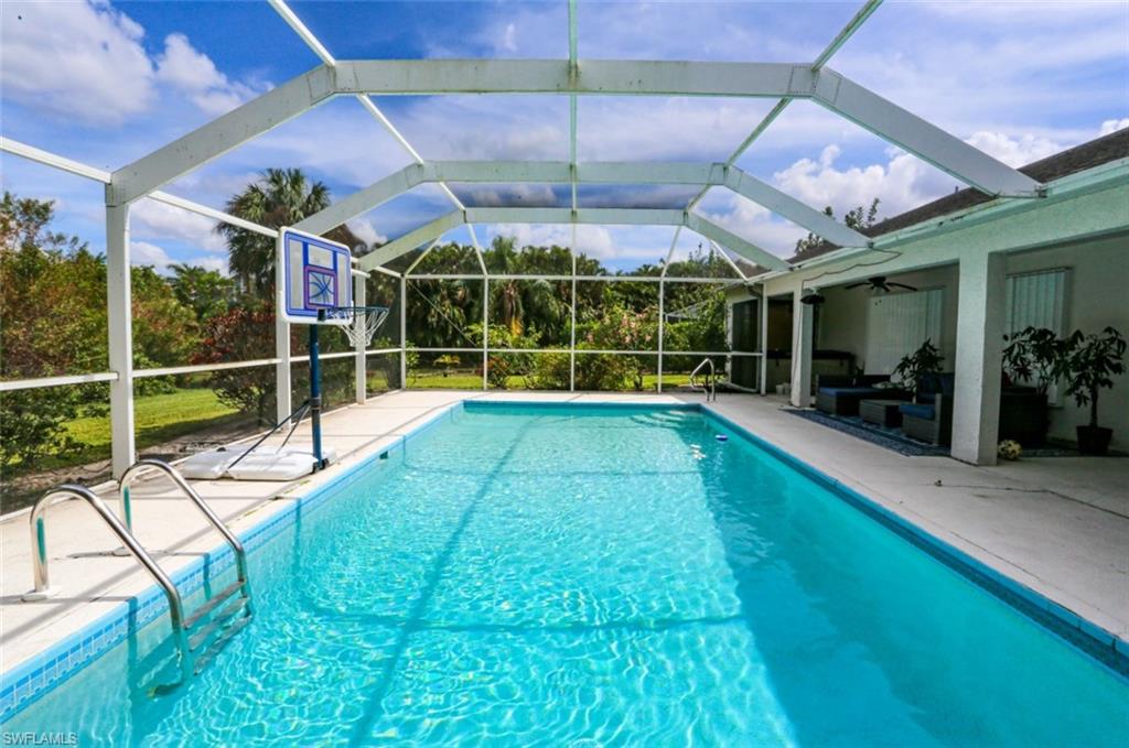 7775 Scarlet Court Naples, FL 34104 - Photo 26 of 30 View of pool with ceiling fan, a lanai, and a patio