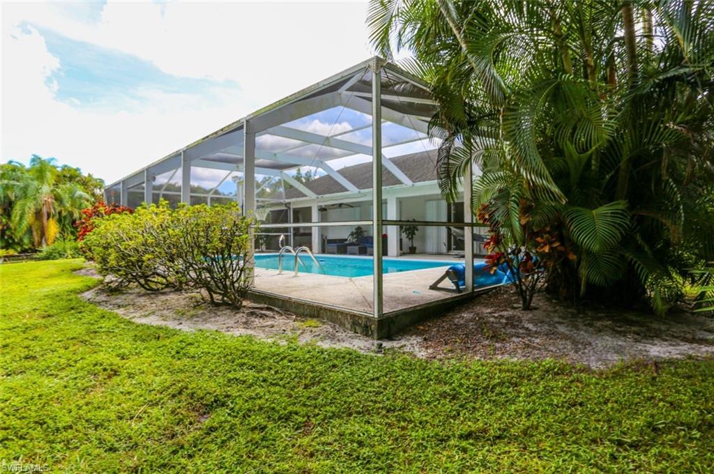 7775 Scarlet Court Naples, FL 34104 - Photo 29 of 30 View of pool with glass enclosure and a yard