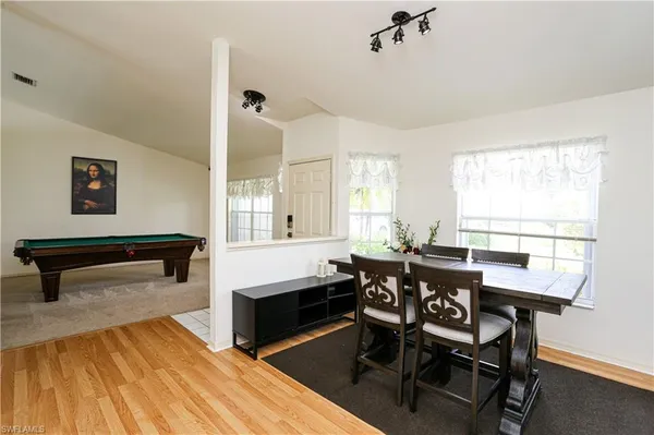 a dining room with furniture and window