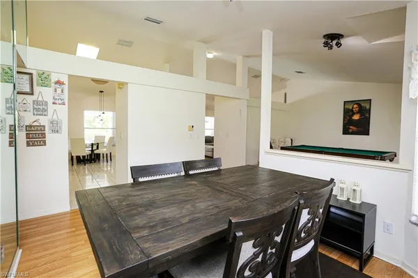 a living room with dining table and wooden floor