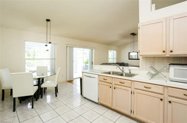 a kitchen with sink cabinets and window