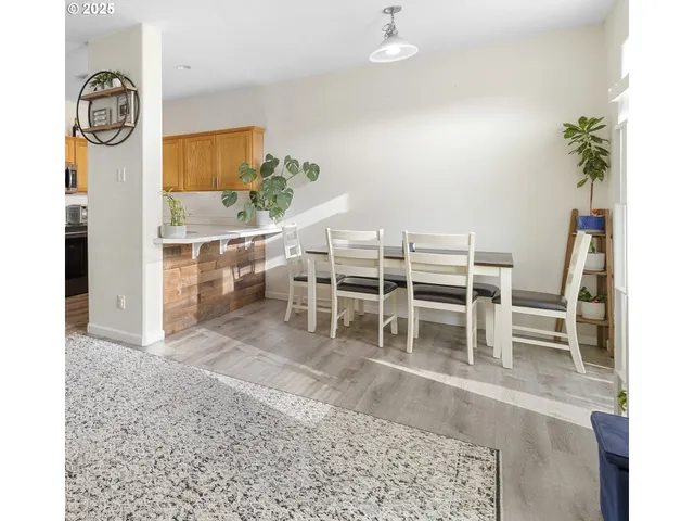 a living room with furniture a rug and white walls