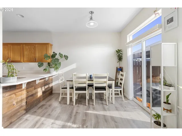 a dining room with furniture and wooden floor