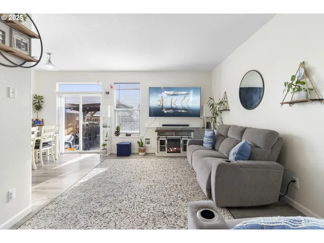 a living room with furniture a fireplace and a flat screen tv