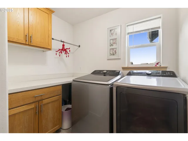 a utility room with sink dryer and washer