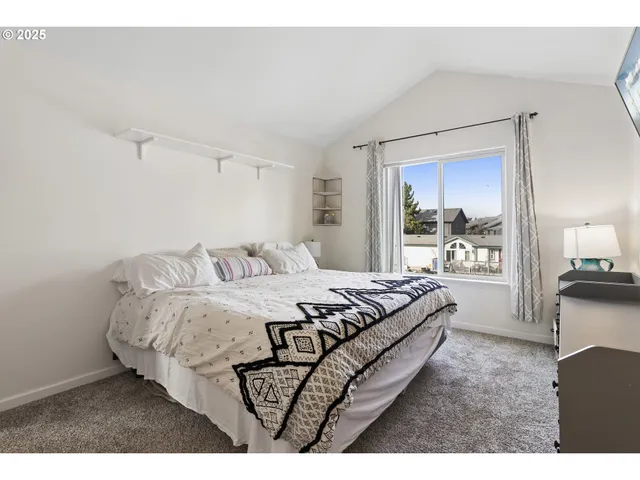 a bedroom with bed and window