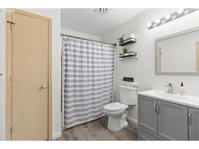 a bathroom with a sink toilet a mirror and shower