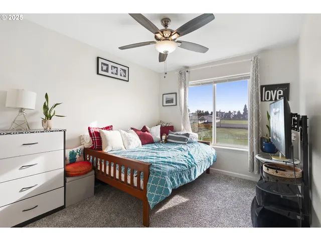 a bedroom with a bed and ceiling fan